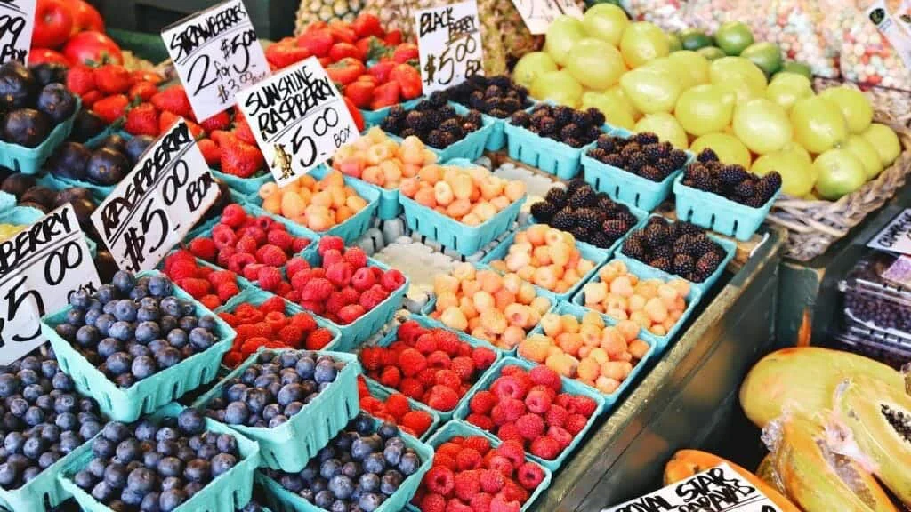 Tips for feeding your family a nutrient dense diet are showcased through an array of fruits and vegetables at a market.