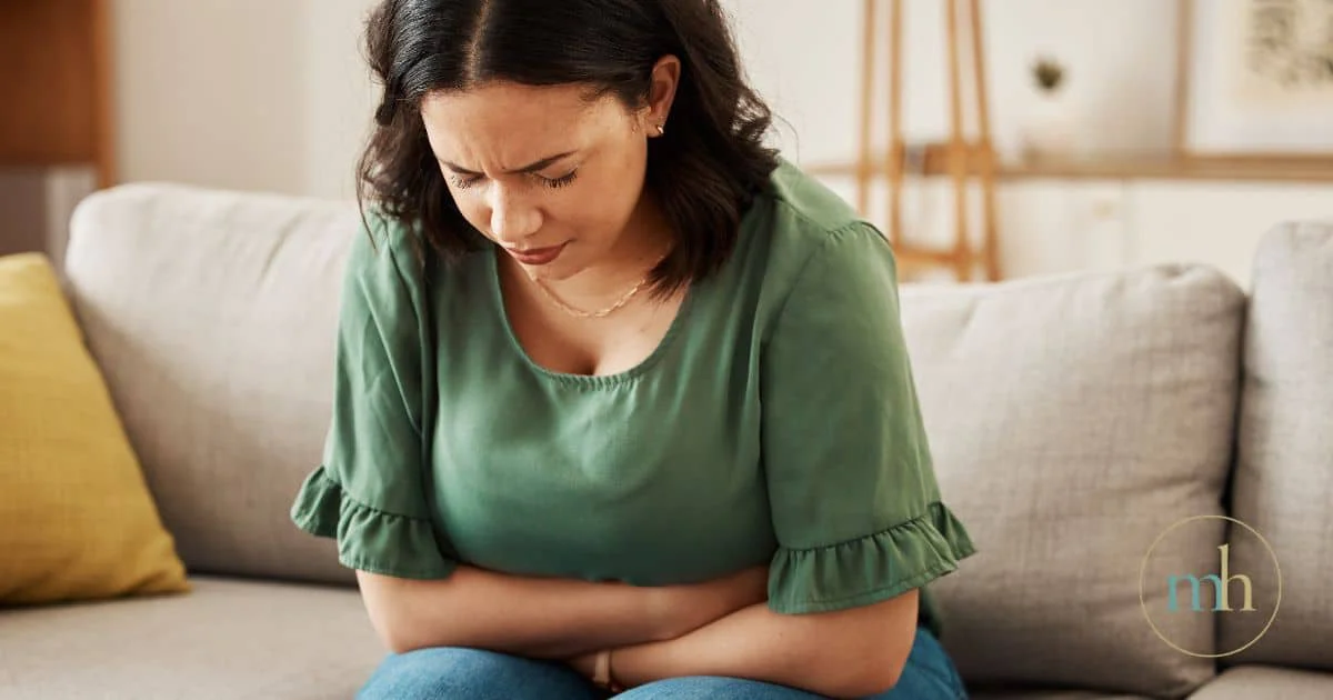 Woman experiencing poor gut health and low energy.